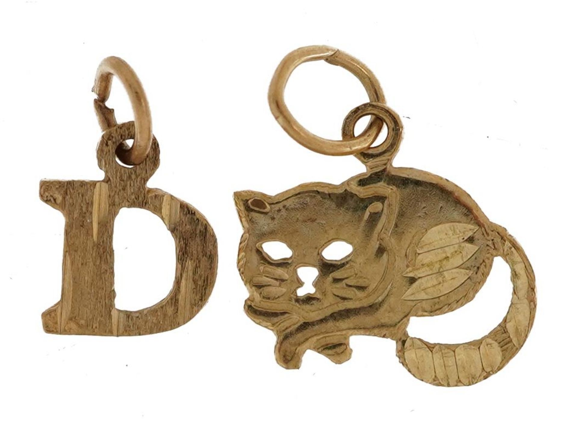 Two 9ct gold charms comprising initial D and cat, the largest 1.2cm wide, total 0.7g : For further