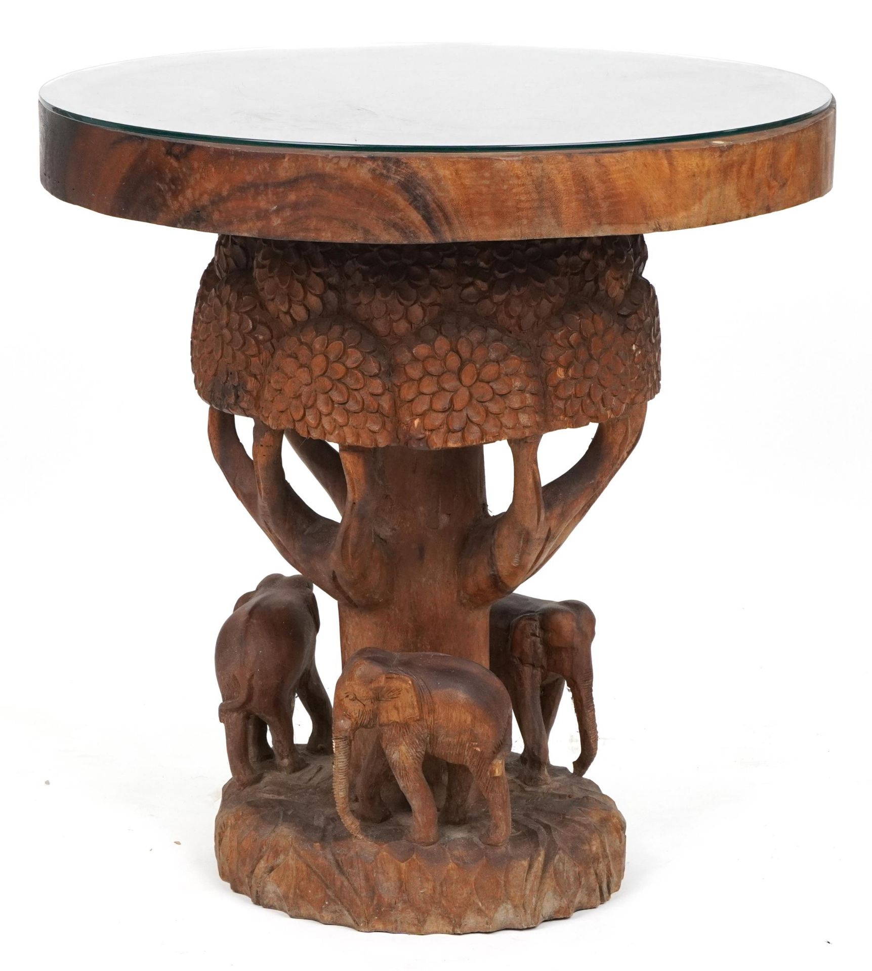 African circular centre table profusely carved with elephants and trees, 80cm high x 75cm in