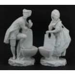 Pair of bisque porcelain figural salts in the style of Chelsea, the largest 26cm high : For