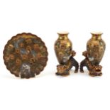 Pair of Japanese Satsuma pottery vases surmounted on Foo dogs and a dish, each hand painted with