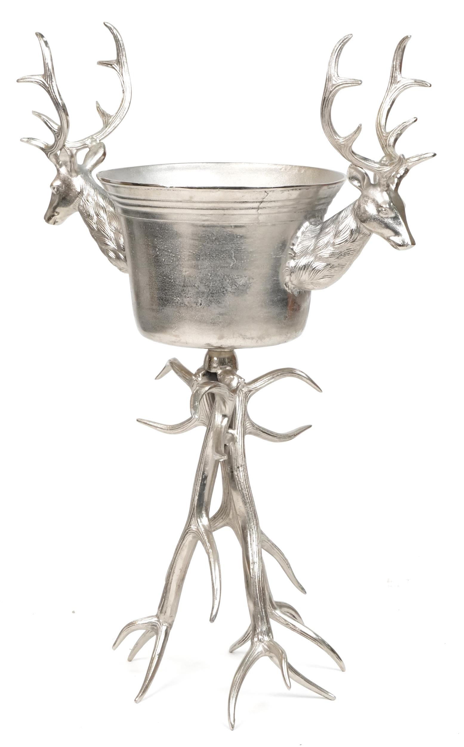 Brutalist style silvered metal floor standing ice bucket with two stag's heads, 105cm high x 70cm