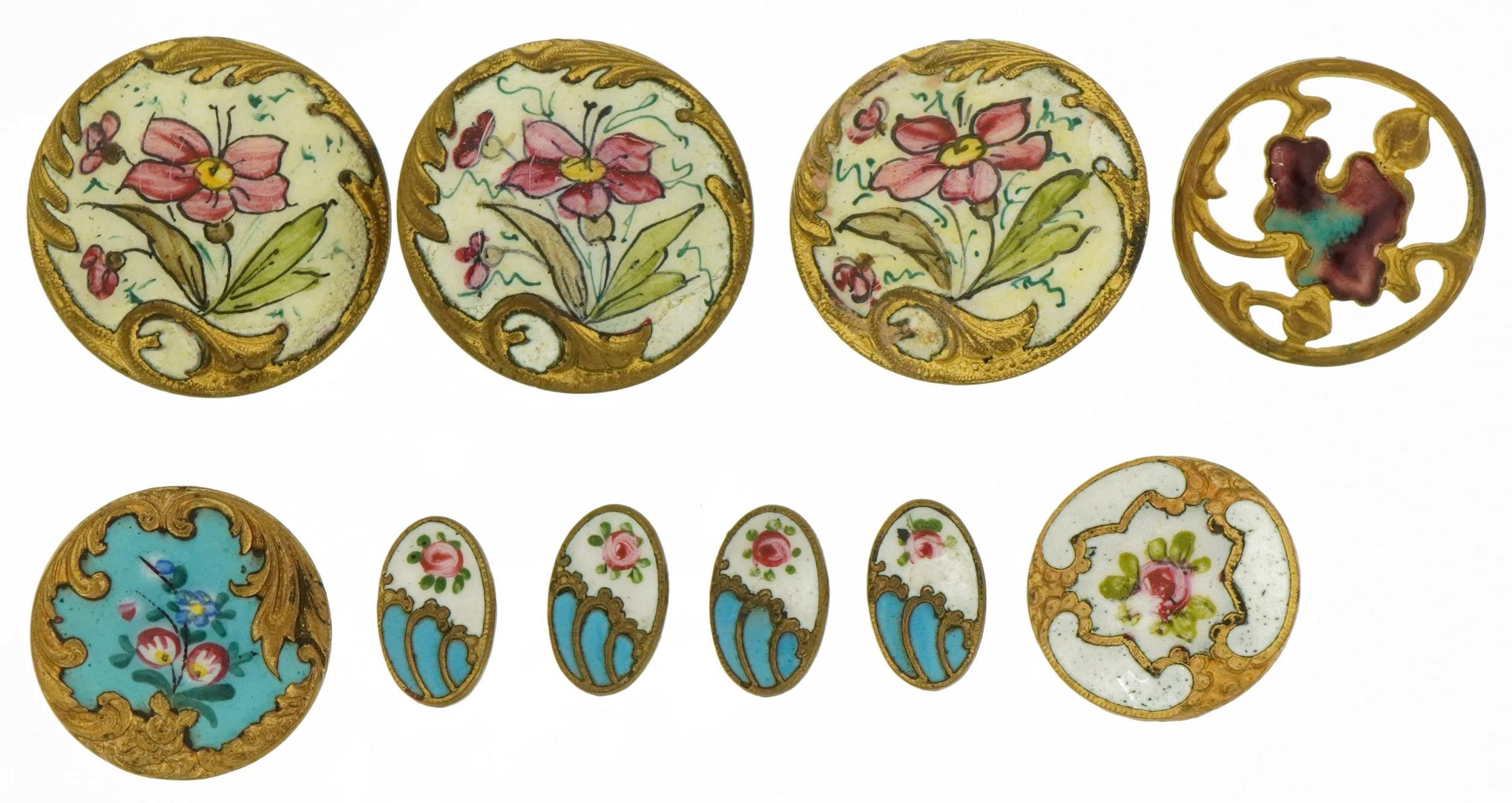 Ten early 20th century brass and enamel buttons comprising nine hand painted with flowers and an Art