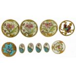 Ten early 20th century brass and enamel buttons comprising nine hand painted with flowers and an Art