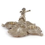 Silver plated acanthus leaf design desk stand surmounted with Putti, 26.5cm wide : For further