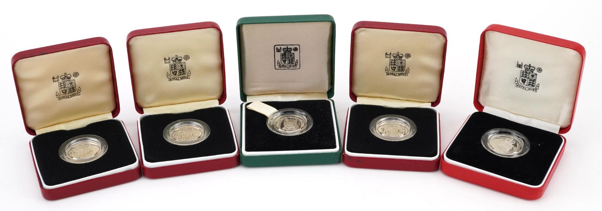 Five United Kingdom silver proof one pound coins by The Royal Mint and a Falkland Islands silver