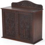 Oak wall hanging two door cupboard carved with stylised flowers, 54cm H x 55.5cm W x 26cm D : For