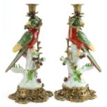 Pair of continental porcelain bird design candlesticks with gilt bronze mounts, each 36cm high : For