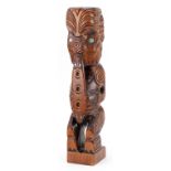 New Zealand hardwood Maori Teko carving with abalone inlay, paper label to the base, 45cm high : For