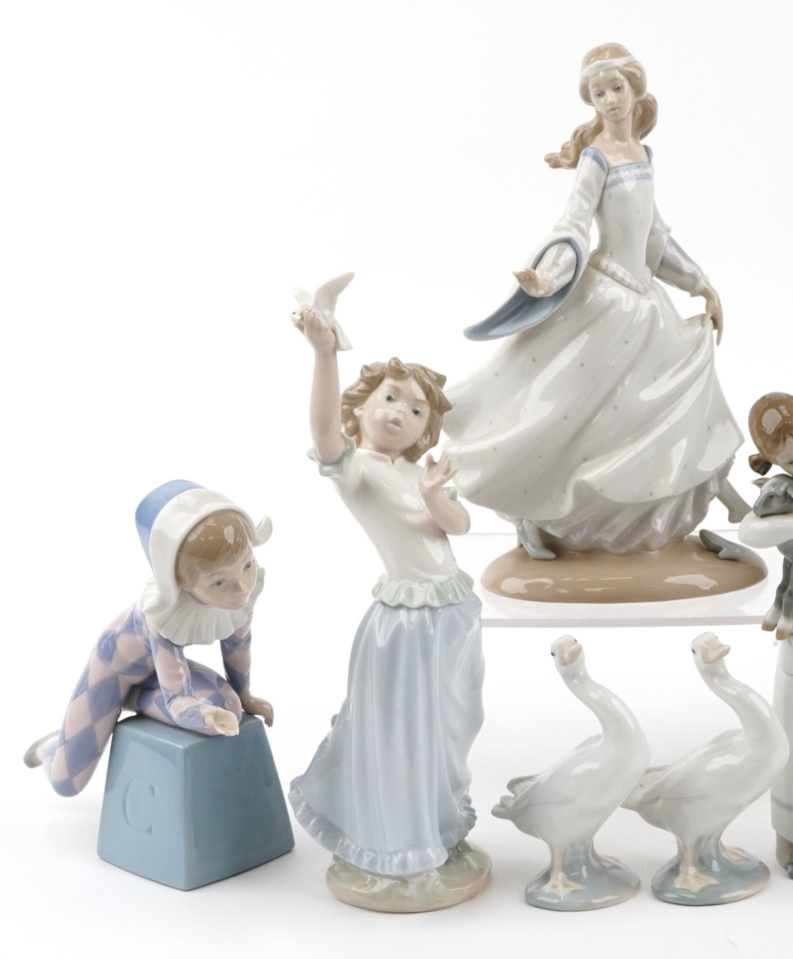 Nine Lladro porcelain figures and animals including a young Pierrot, girl with oranges and girl with - Image 2 of 4
