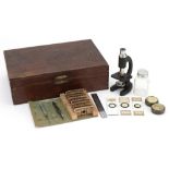 Miniature travel microscope with slides arranged in a fitted wooden travelling case, the case 25cm