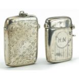 Two rectangular silver vestas including one engraved with foliage, the largest 4.6cm high, total