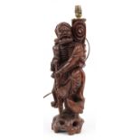 Large Chinese carved root wood table lamp in the form of an elder holding a staff, 53.5cm high : For