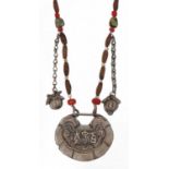 Chinese unmarked silver pendant embossed with calligraphy on white metal and bead necklace, the