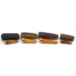 Four late19th/early 20th century butterscotch amber cigarette holders with 9ct gold mounts, each