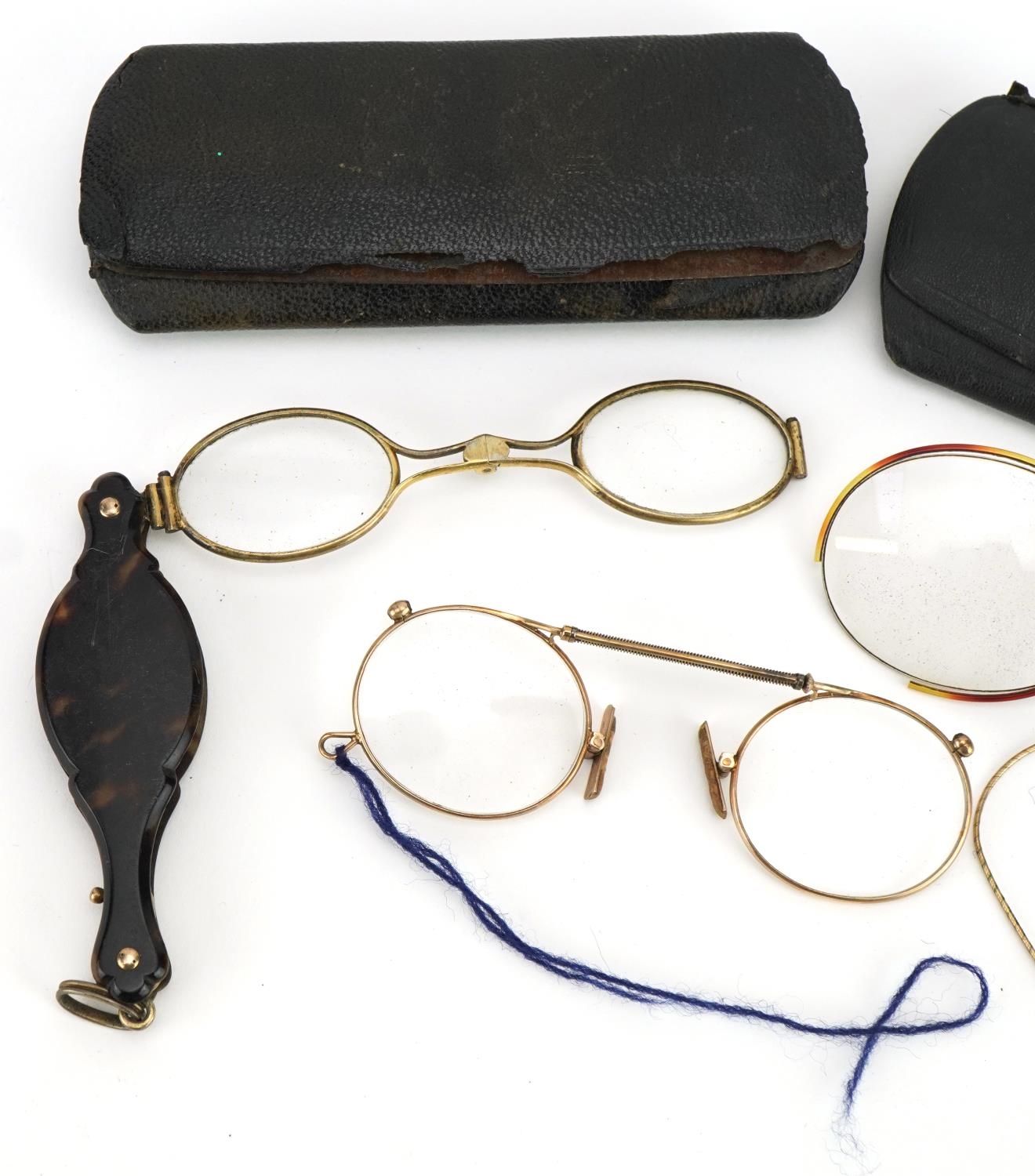 Three pairs of early 20th century spectacles comprising one with tortoiseshell handle and two yellow - Image 2 of 3