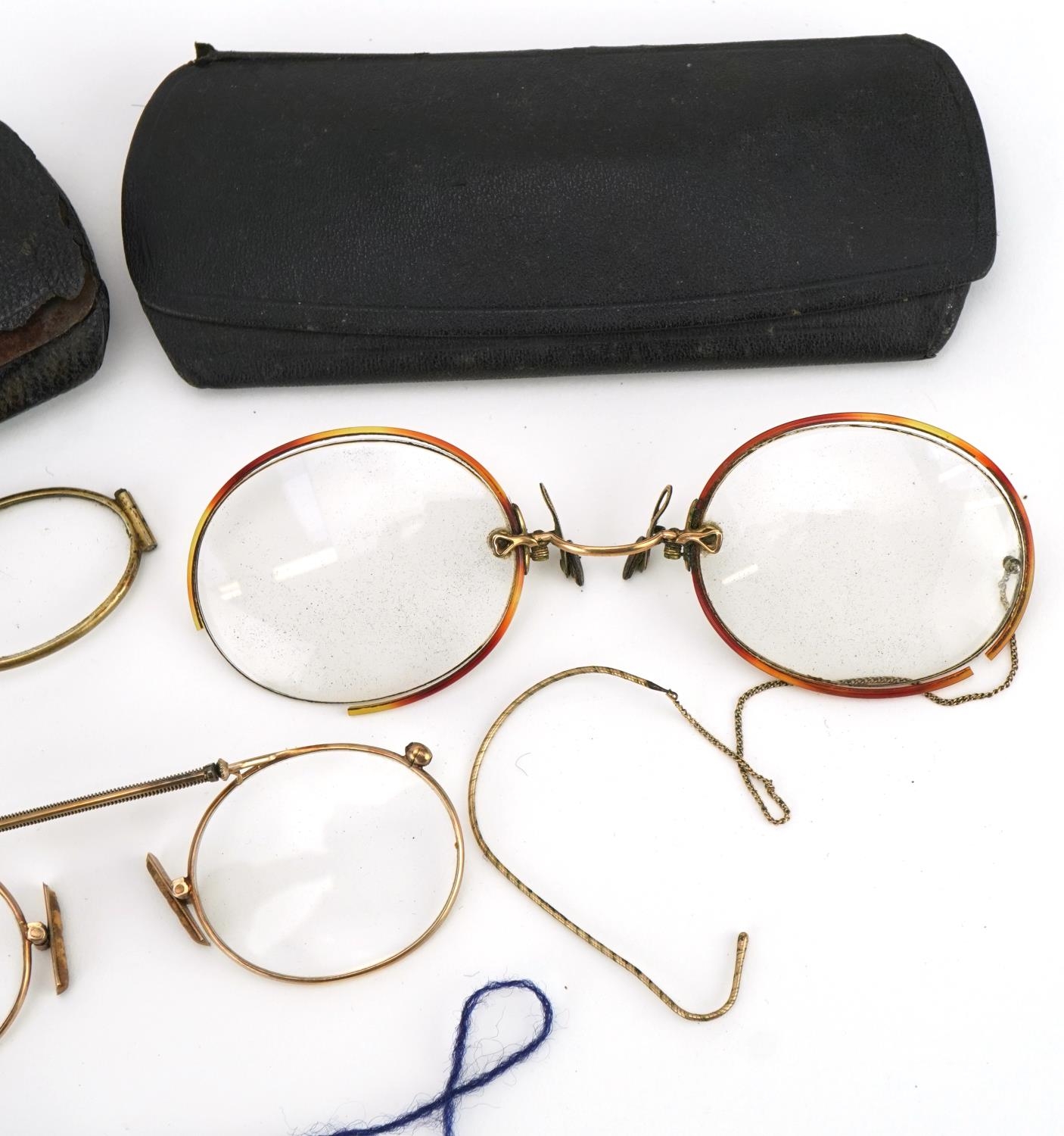 Three pairs of early 20th century spectacles comprising one with tortoiseshell handle and two yellow - Image 3 of 3