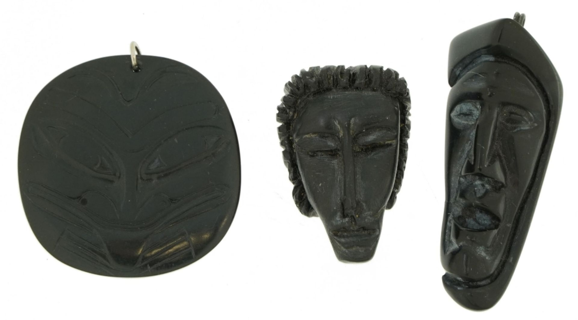 Three Haida Argillite carvings including a Maori type example, the largest 6cm high : For further