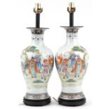 Pair of Chinese porcelain baluster vase table lamps raised on hardwood stands, each hand painted