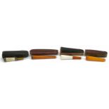 Four late 19th/early 20th century cigarette holders including two butterscotch amber examples and