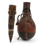 Tribal interest African leather bound wood gourd and one other, the largest 40cm high : For