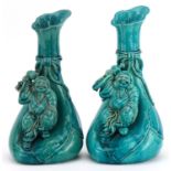 Matched pair of Chinese sack design vases surmounted with figures having turquoise glazes, each 26.