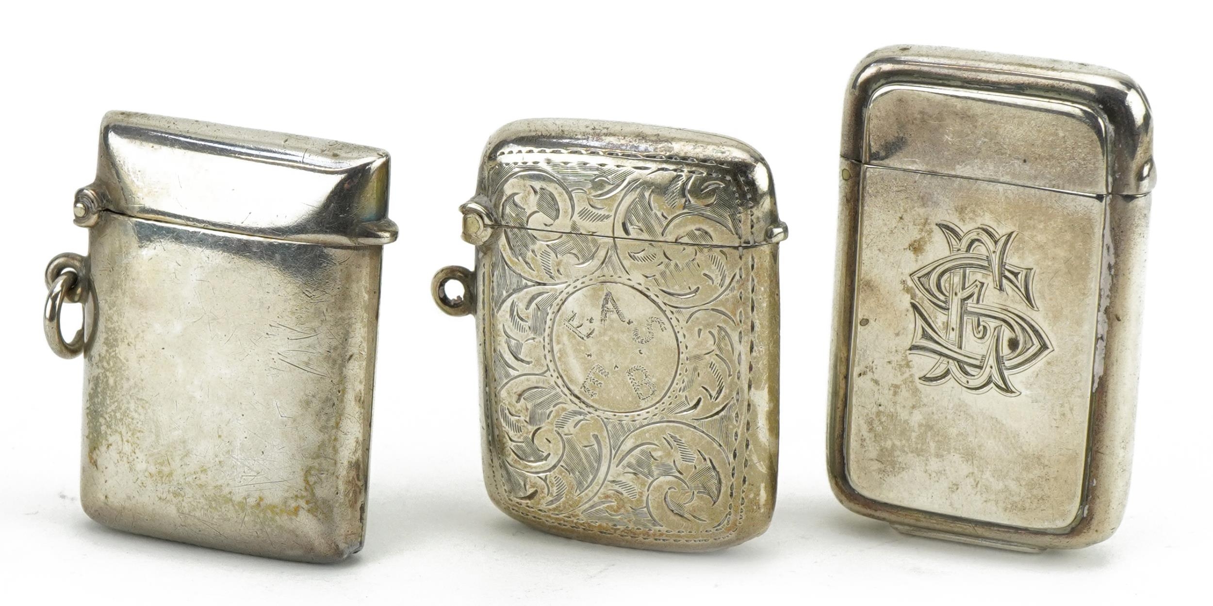 Three Victorian and later silver vestas, one with engraved decoration, the largest 5cm high, total
