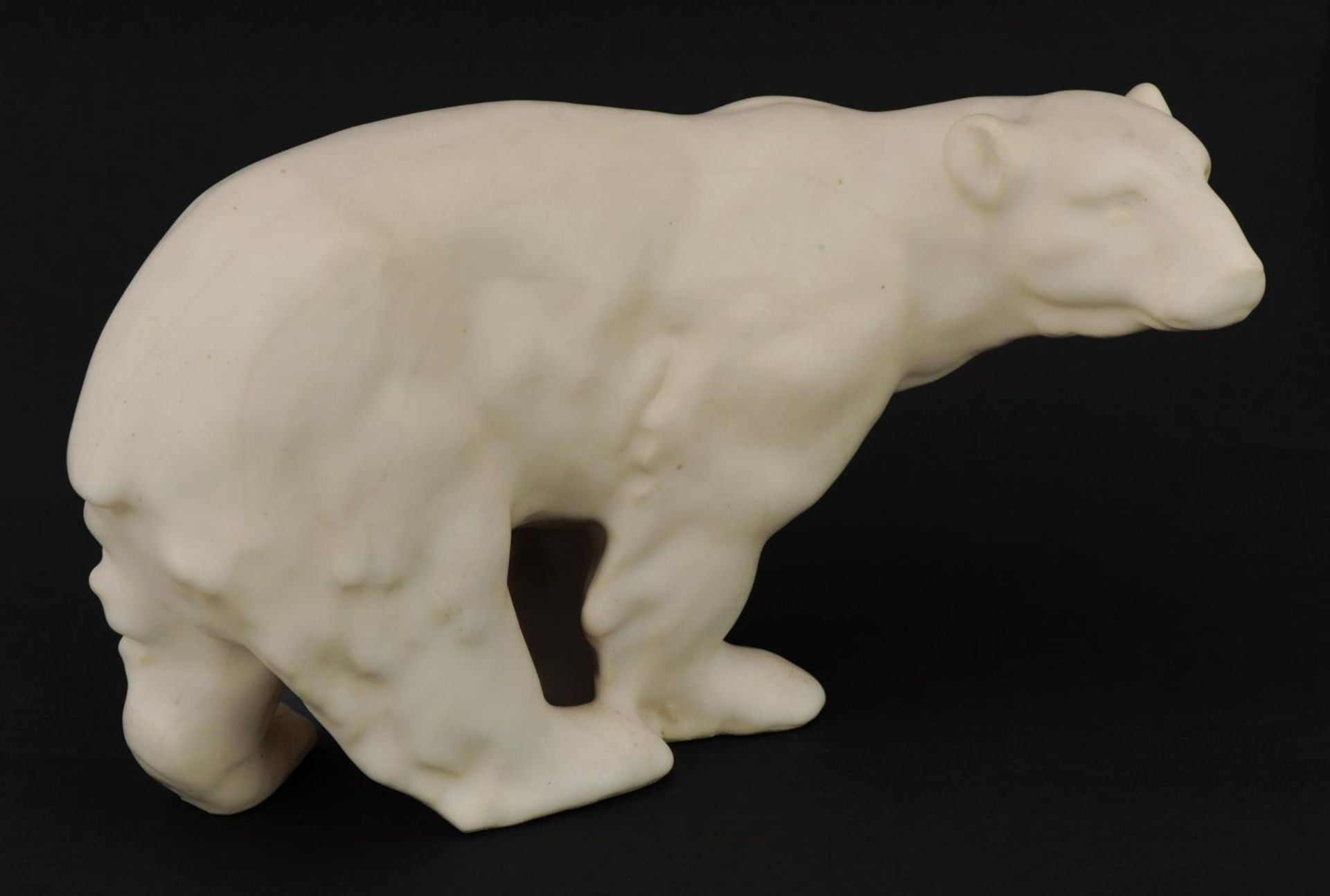 French Art Deco polar bear having a cream glaze stamped Made in France to the base, 26.5cm in length