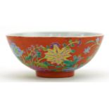 Chinese porcelain red ground bowl hand painted in the famille rose palette with flowers, four figure