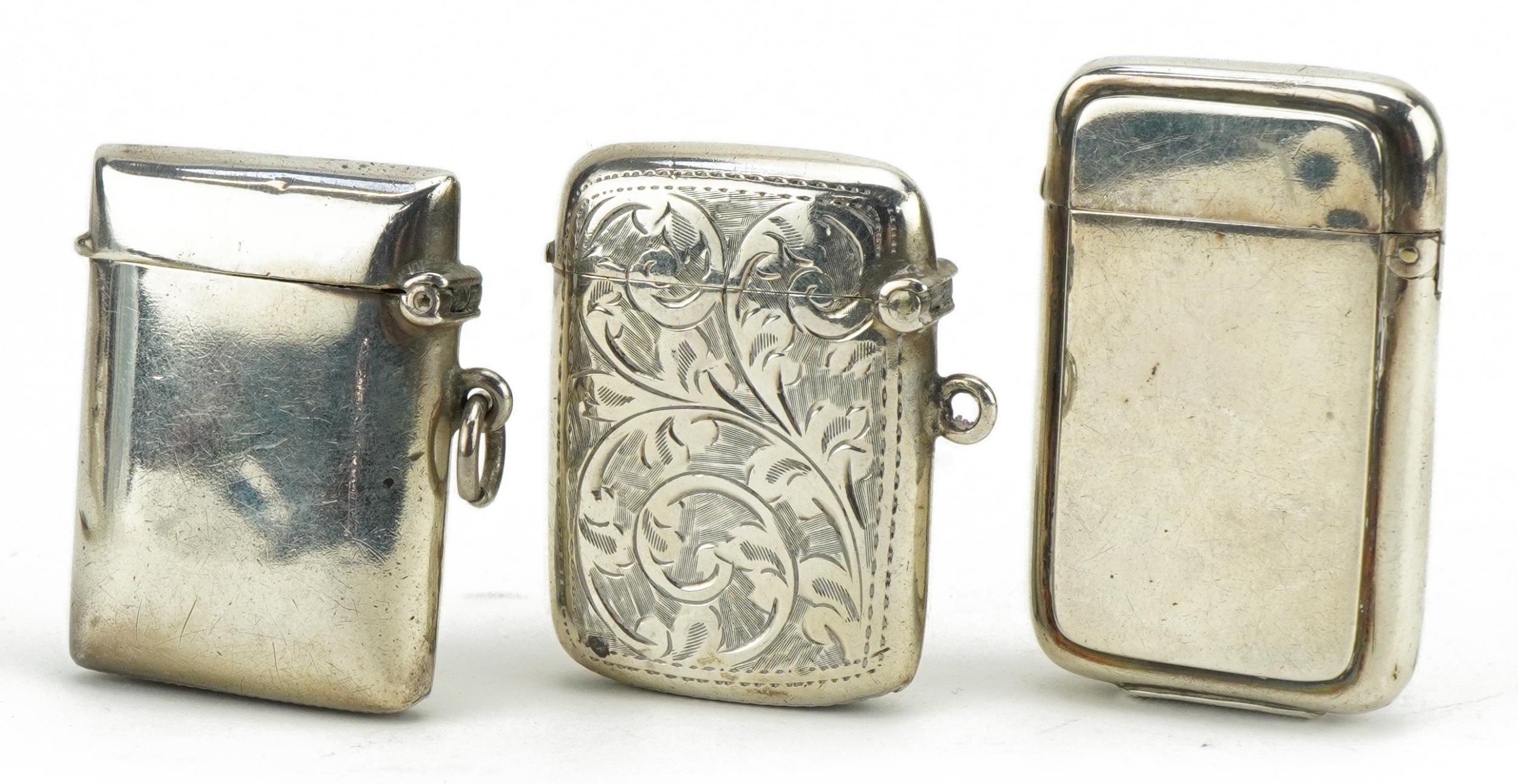 Three Victorian and later silver vestas, one with engraved decoration, the largest 5cm high, total - Image 2 of 3