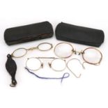 Three pairs of early 20th century spectacles comprising one with tortoiseshell handle and two yellow