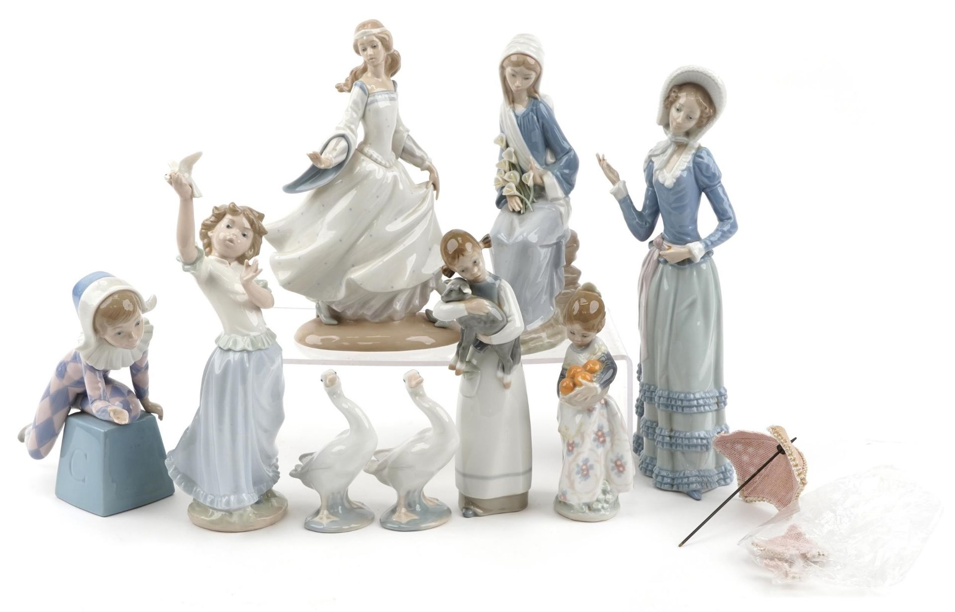 Nine Lladro porcelain figures and animals including a young Pierrot, girl with oranges and girl with