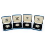 Four United Kingdom silver proof one pound coins by The Royal Mint with certificates and cases