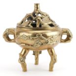 Chinese patinated bronze tripod censer with twin handles and pierced cover decorated in relief