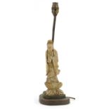 Chinese carved green hardstone Guanyin table lamp with a stepped brass base engraved with foliage,