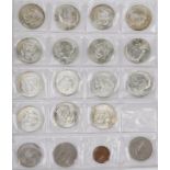 Collection of British and American coins arranged in a folder including half dollars and pennies :