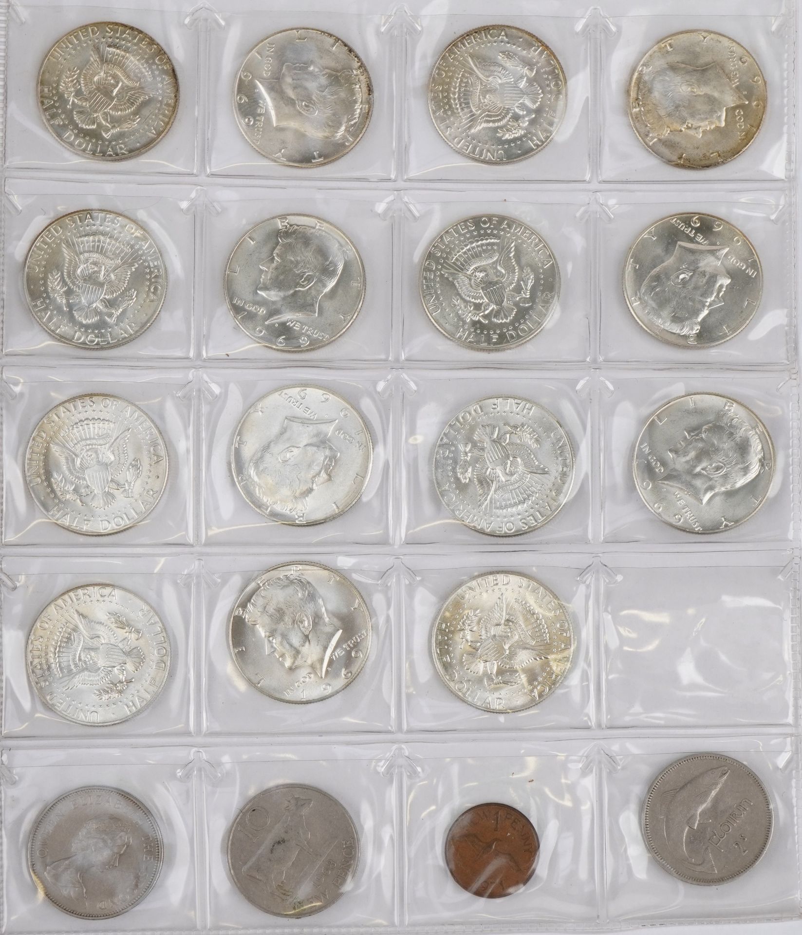 Collection of British and American coins arranged in a folder including half dollars and pennies :