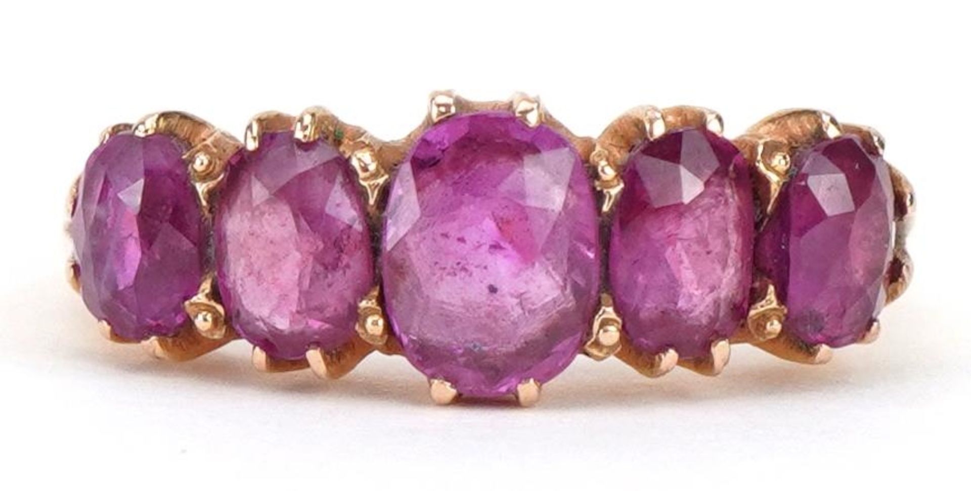 Unmarked gold ruby graduated five stone ring, tests as 18ct gold, possibly Indian, the largest