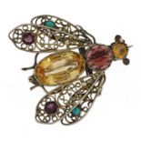Unmarked silver filigree fly brooch set with semi precious stones including garnet, yellow topaz and
