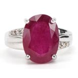9ct white gold ruby solitaire ring with diamond set shoulders, the ruby approximately 13.3mm x 9.