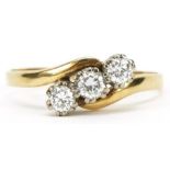 18ct gold diamond three stone crossover ring, total diamond weight approximately 0.33 carat, size V,