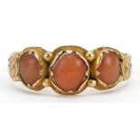 Antique unmarked gold coral three stone ring with engraved shoulders, tests as 15ct gold, size P,