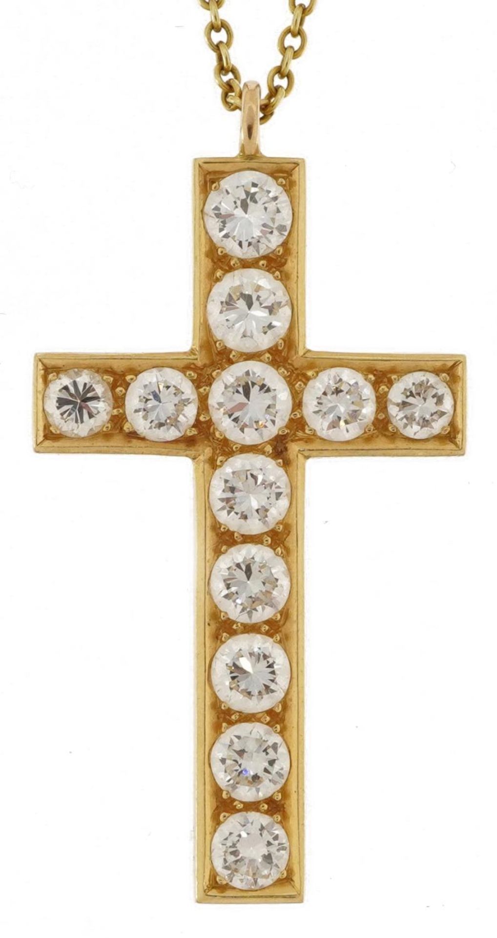 Unmarked gold cross pendant set with twelve diamonds of varying sizes, the largest diamond