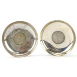 Pair of Indian circular silver 1835 and 1840 one rupee coin dishes, 8cm in diameter, 77.8g