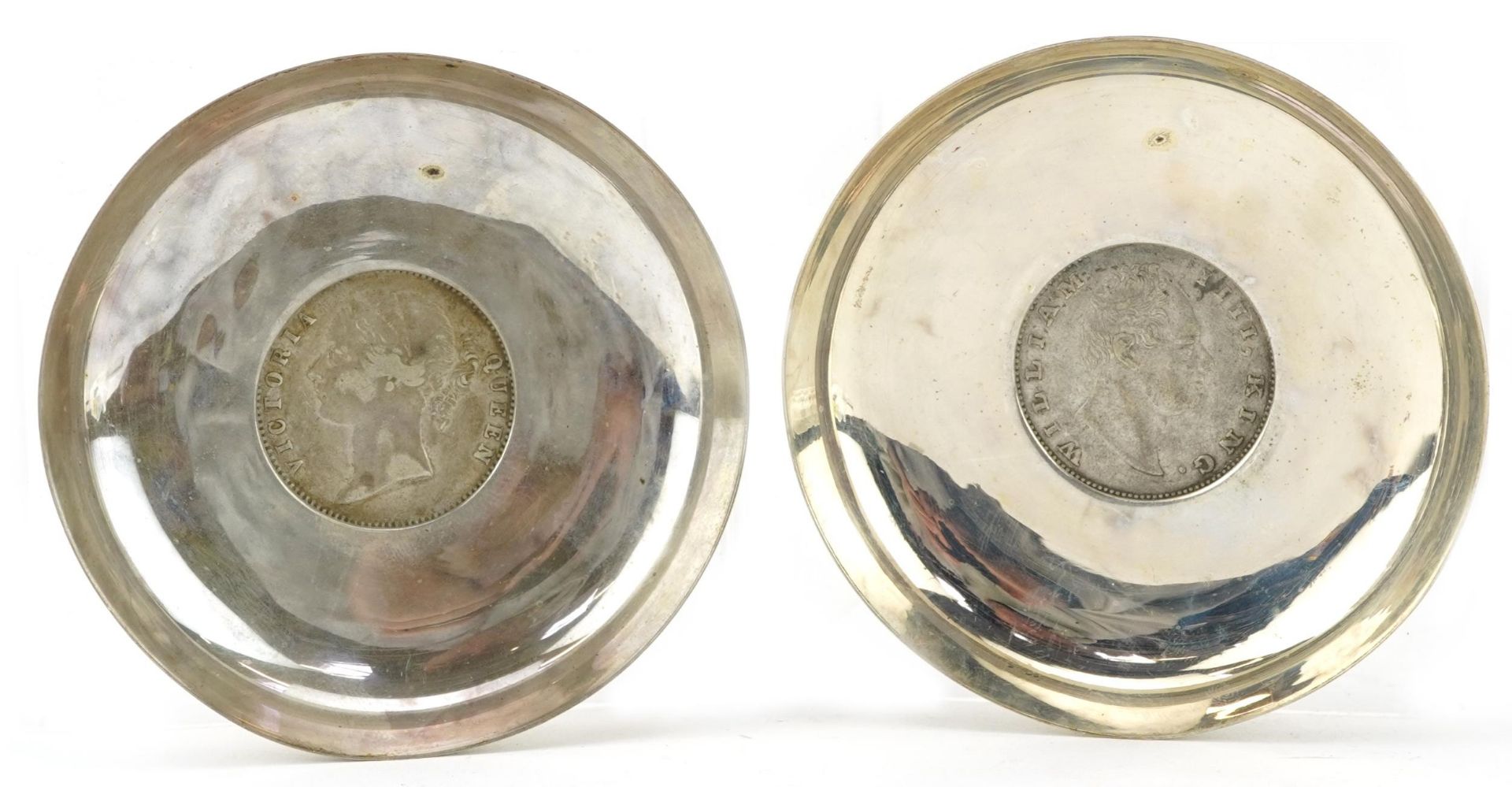 Pair of Indian circular silver 1835 and 1840 one rupee coin dishes, 8cm in diameter, 77.8g