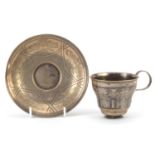 Russian silver niello work cup and saucer, impressed marks to the base, the saucer 12.5cm in