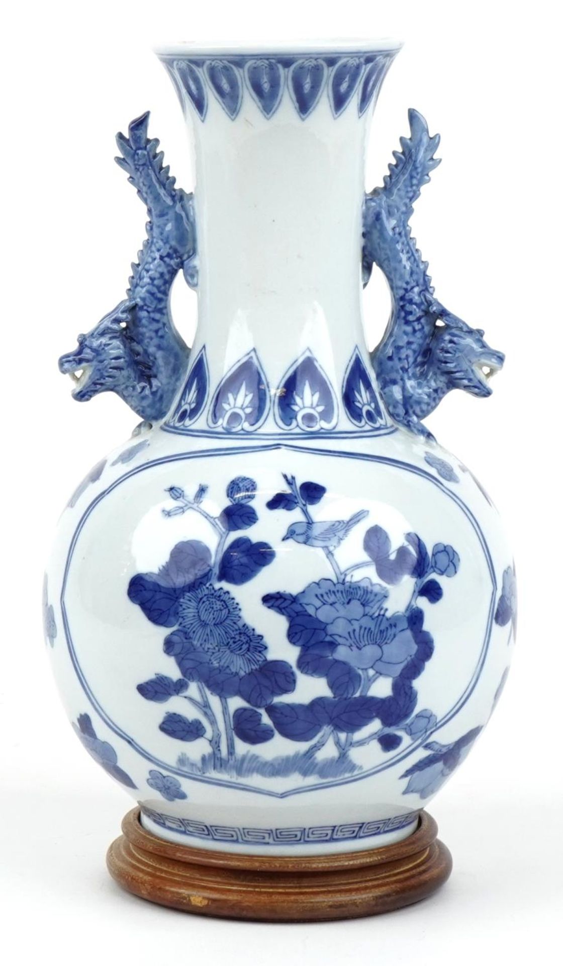 Chinese blue and white porcelain vase with dragon handles raised on a hardwood stand, decorated with