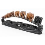 African ebony stand surmounted with nine graduated hardwood elephants, the stand inlaid Ceylon, 78cm