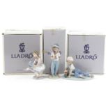 Three Lladro porcelain figures with boxes comprising Boy with Train, Boy with Baseball Bat and
