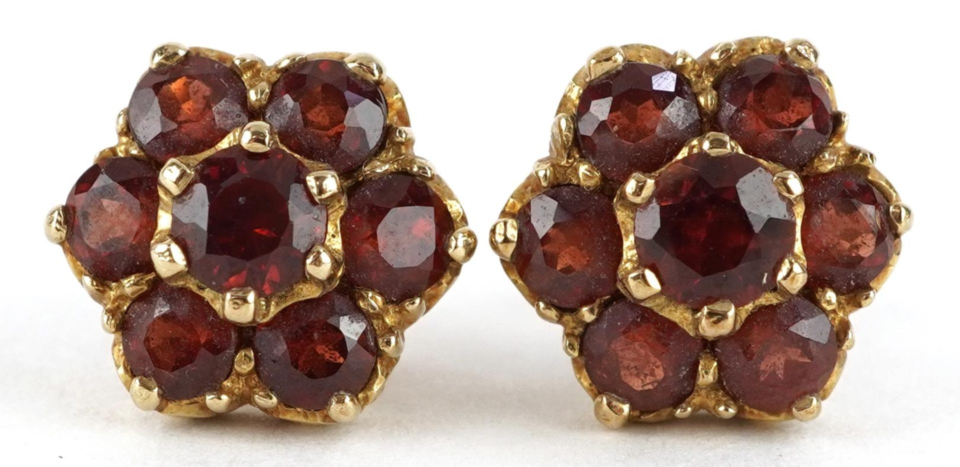 Pair of 9ct gold Bohemian garnet flower head stud earrings, one butterfly marked 750, 1.1cm in