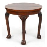 Circular walnut quarter veneered occasional table with shell carved knees and ball and claw feet,